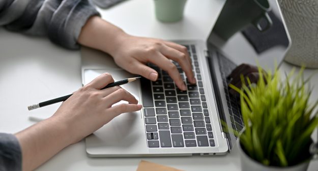 Cropped shot of female college student working at minimal worktable