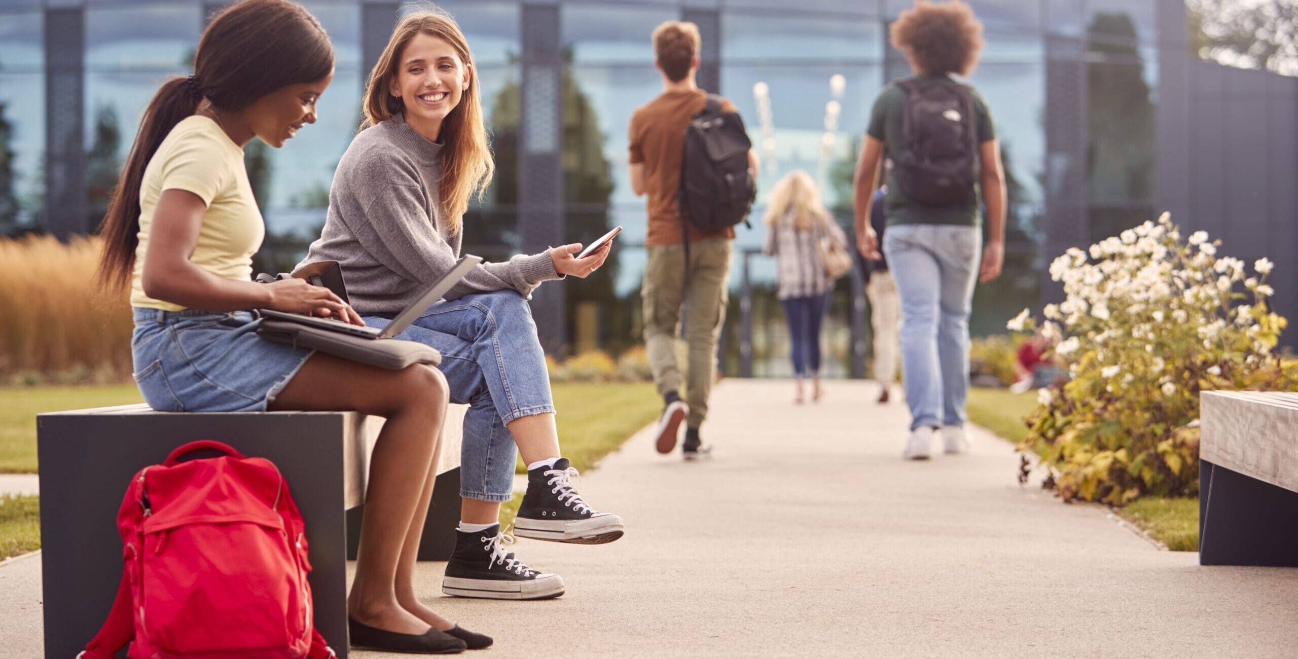 female-university-or-college-students-sitting-outd-2023-11-27-05-22-18-utc (2)