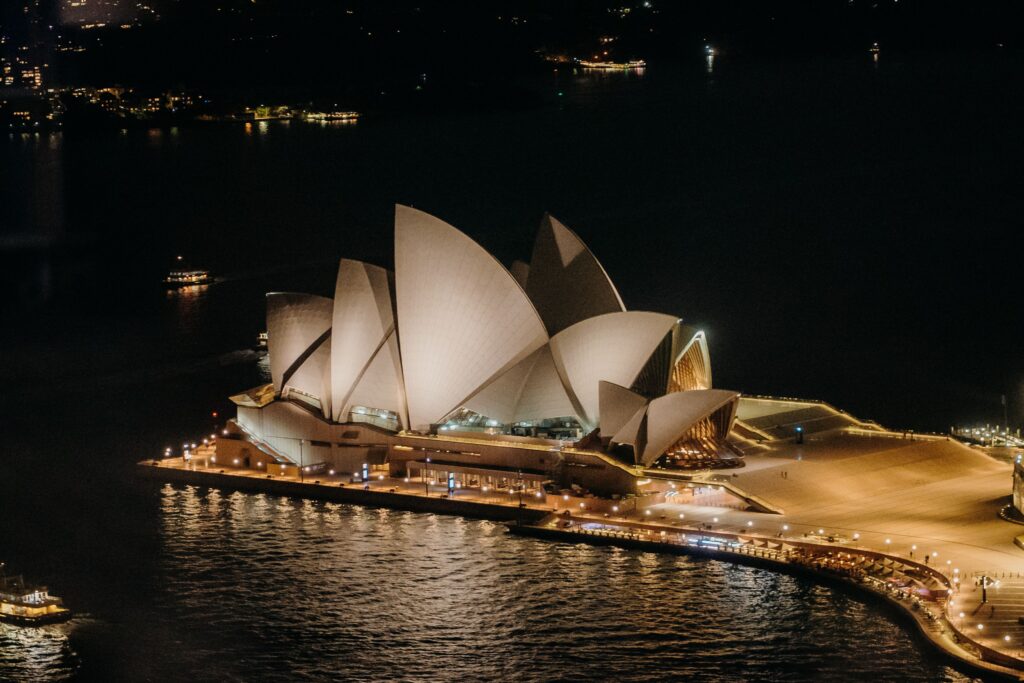 Aerial view of the beautiful Sydney Opera House illuminated at night