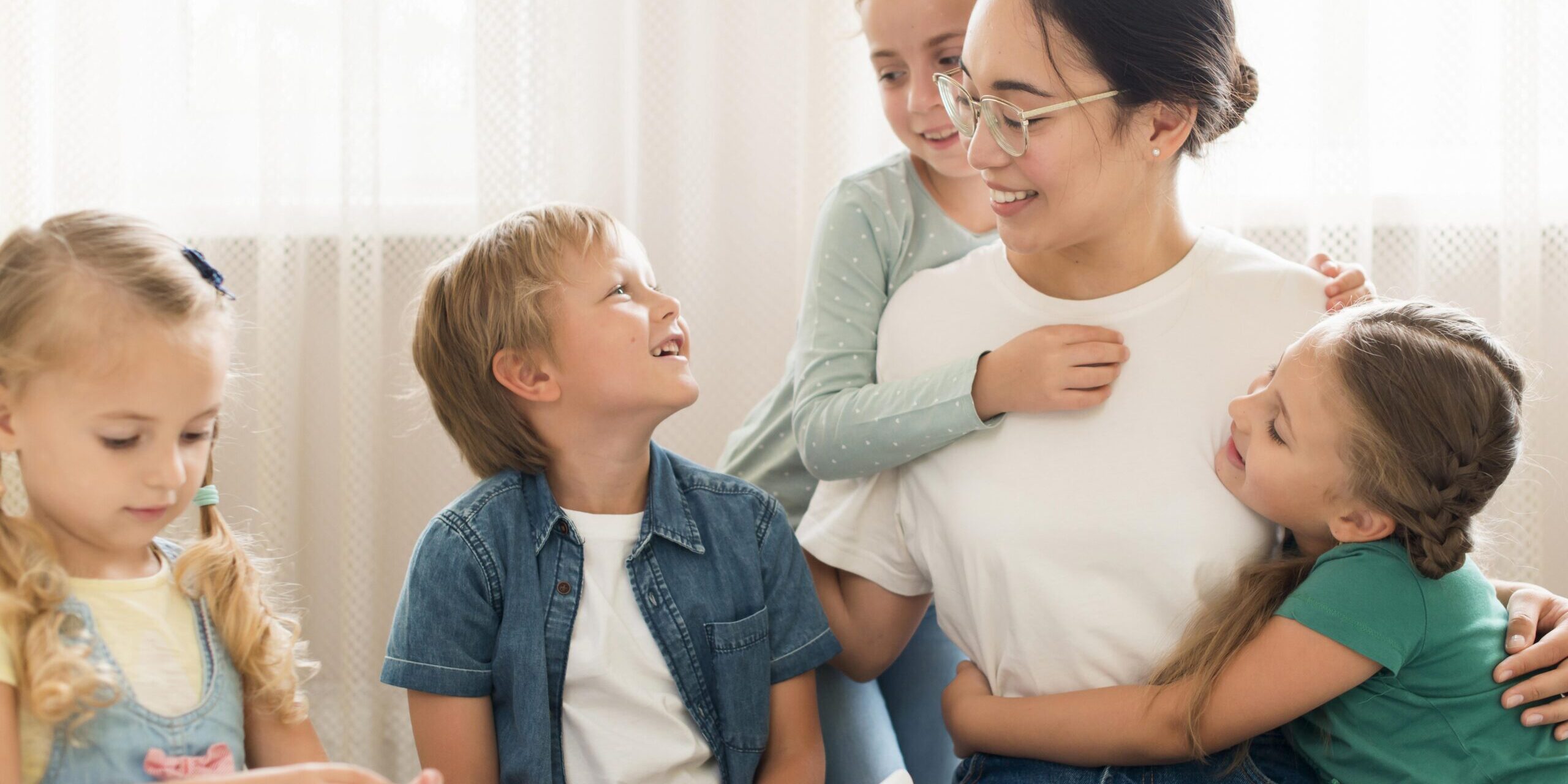 front-view-kids-hugging-their-teacher